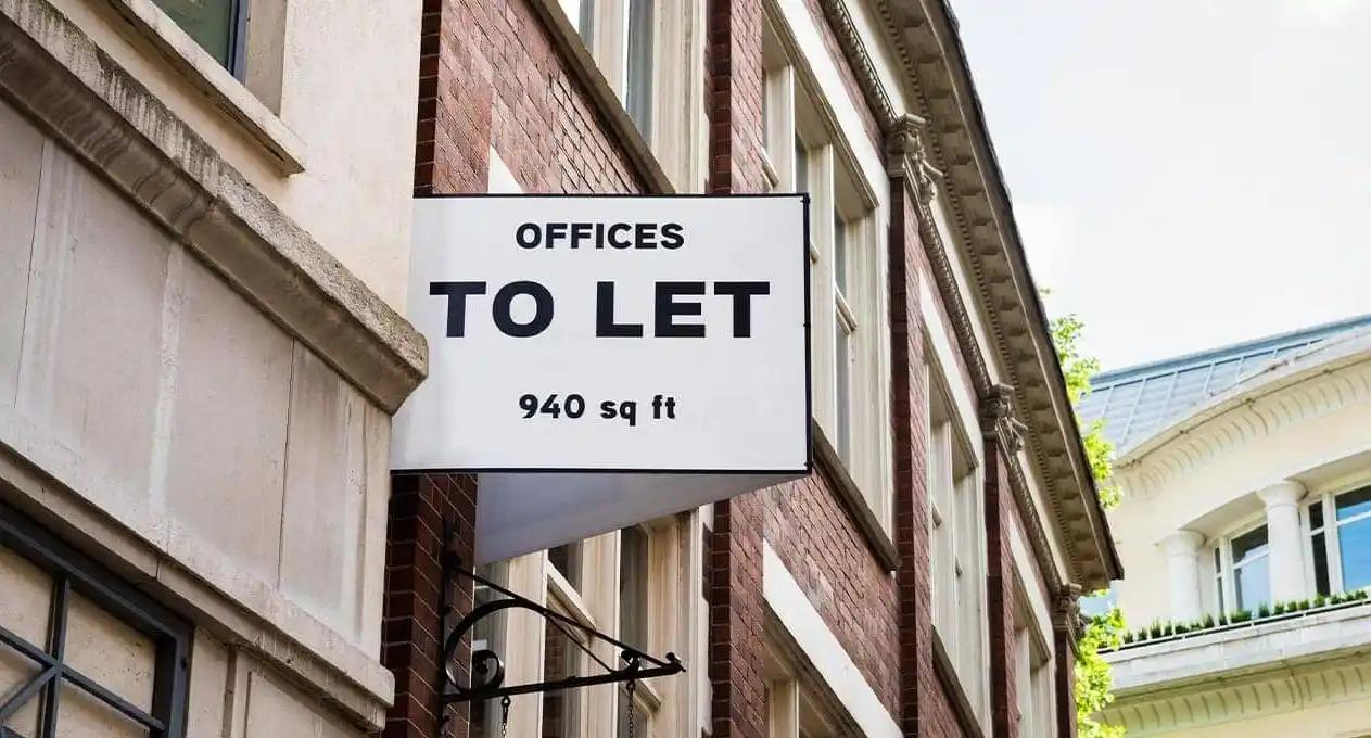  A building displays a sign stating "Offices to Let," suggesting available office rental opportunities.
