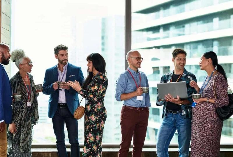 Business people networking with drinks in a breakout area