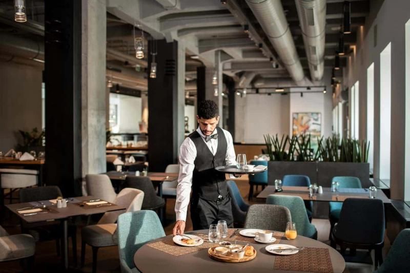 Waiter laying a table in a restaurant