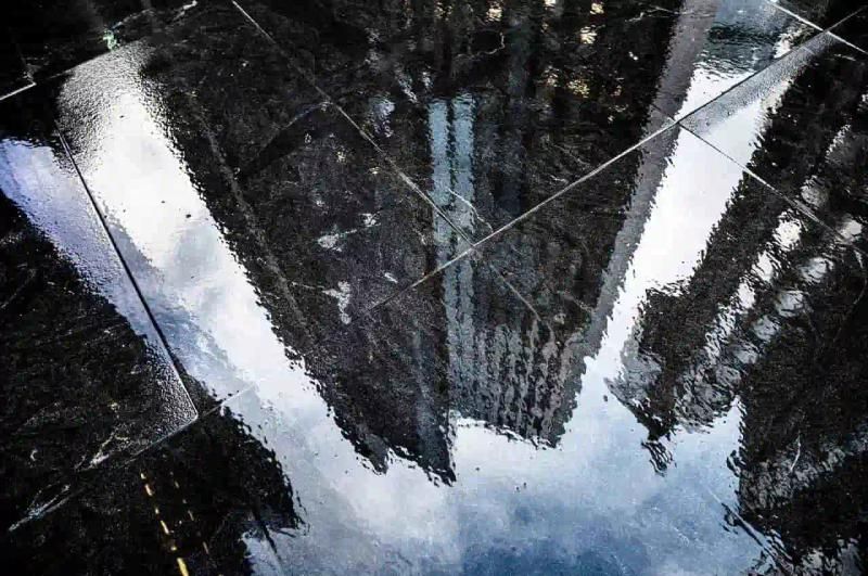 Business district reflection in a puddle