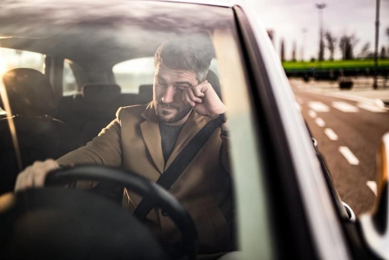 Tired driver behind the wheel of a car