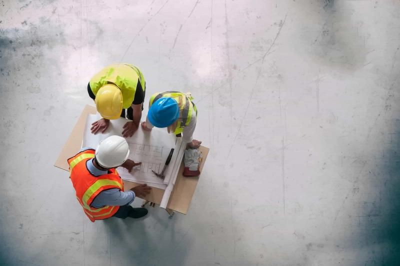 Construction contractors looking at planning documents