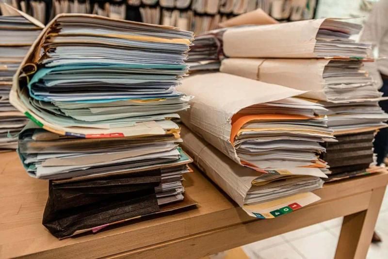 Stacks of folders containing business documents