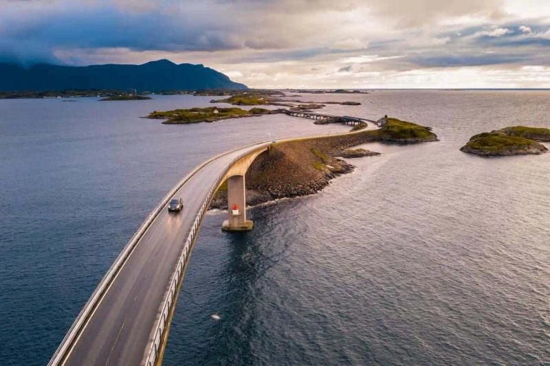 Car driving on a long bridge over water
