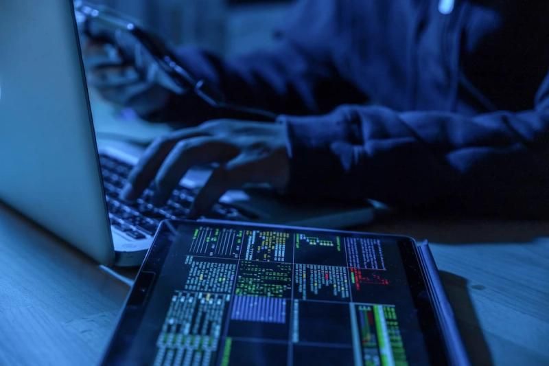 Cyber criminal using a laptop