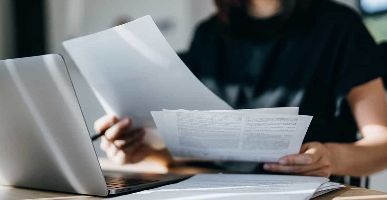 Close up of a person looking through paper work