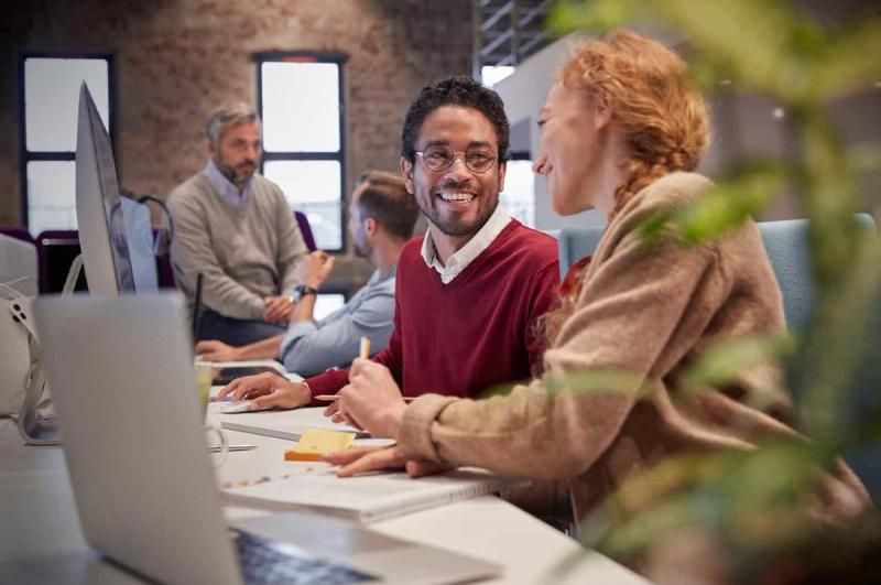 two people in a busy office